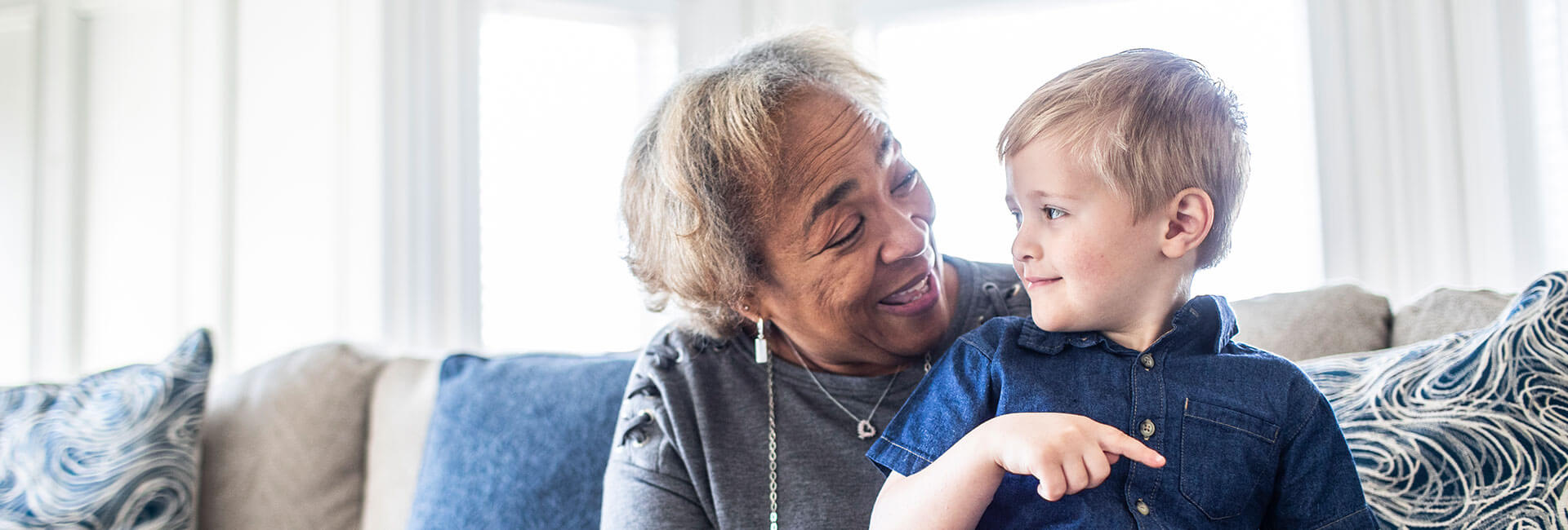 Grandmother reading book with toddler grandson