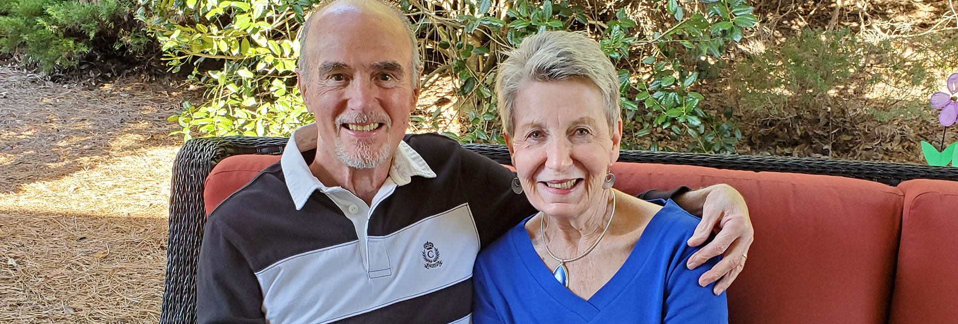Hank and Mary sitting on a couch outside.