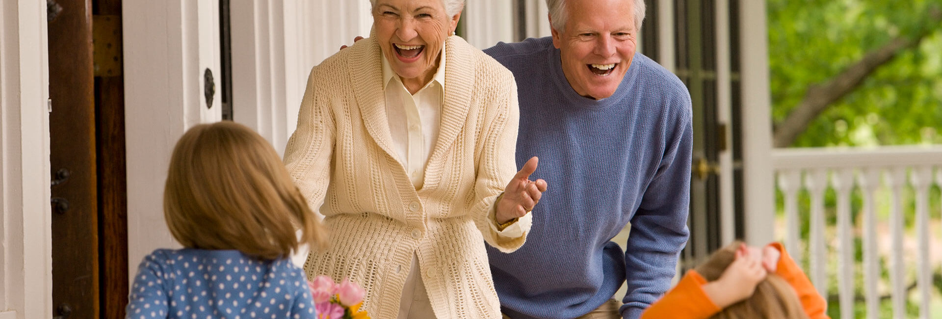 Grandparents Greeting Kids at Front Door
