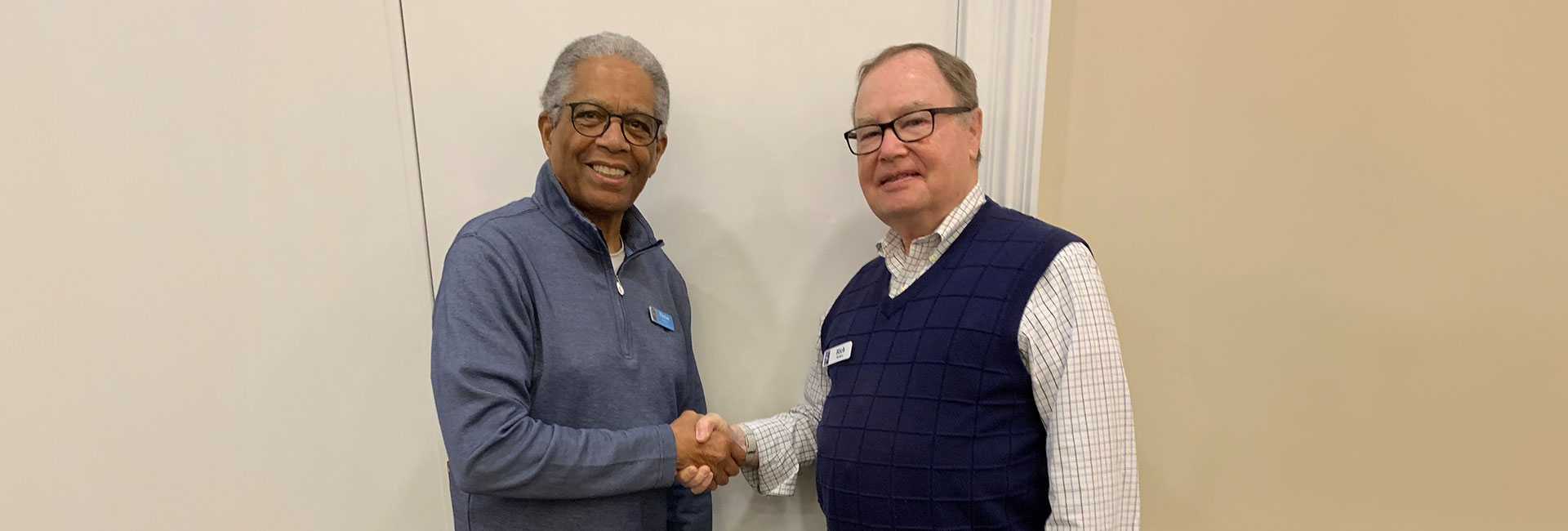 Two men shacking hands.