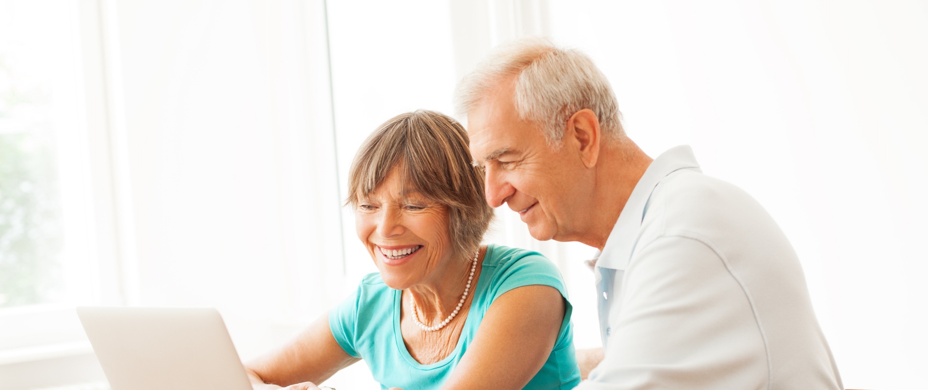 Happy senior couple navigating the internet